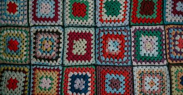 Colorful crocheted granny square fabric for a handmade cardigan