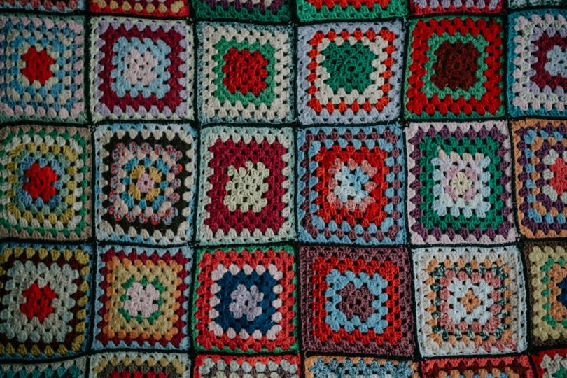 Colorful crocheted granny square fabric for a handmade cardigan