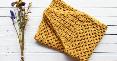Orange handmade crochet textile suitable for a poncho project