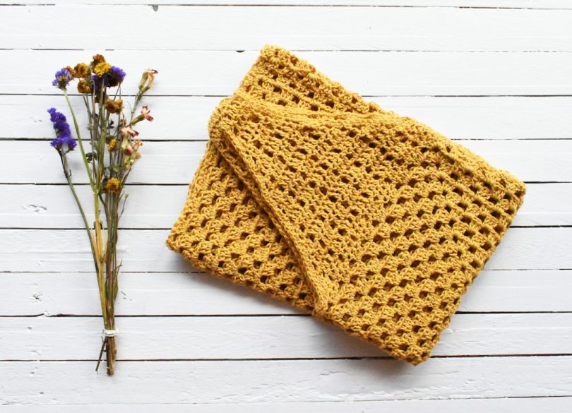 Orange handmade crochet textile suitable for a poncho project