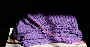 Yarn project in progress with crochet texture and tools