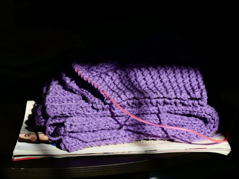 Yarn project in progress with crochet texture and tools