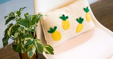 Handmade geometric crochet pillow showing tapestry-style colorwork