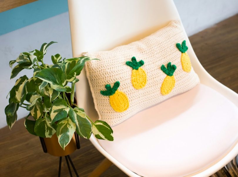 Handmade geometric crochet pillow showing tapestry-style colorwork
