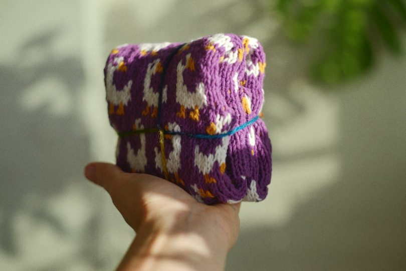 Purple handmade crochet fabric with a contrasting geometric pattern