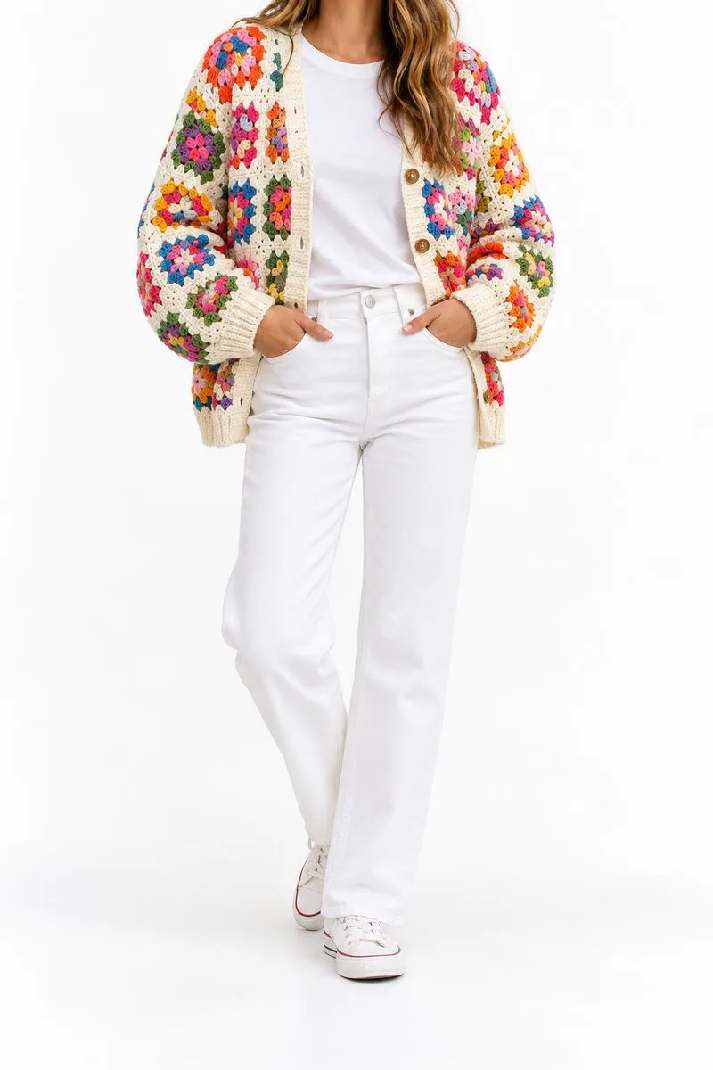 Colorful granny-square crochet cardigan styled with white jeans and a plain tee.